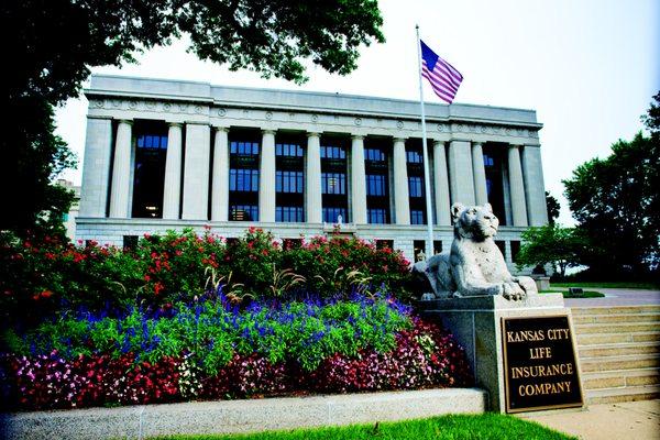 Kansas City Life Insurance Company building and lioness sculpture in spring.