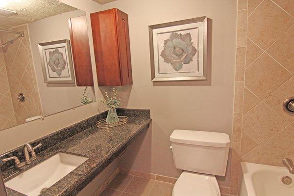 Beautiful, spacious granite countertops and tile tub surround.