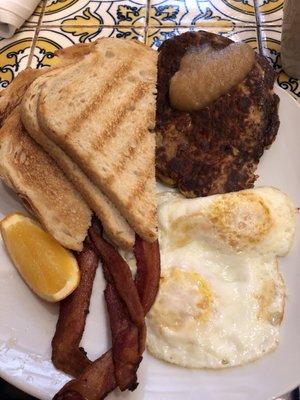 Eggs and bacon with potato pancake and sourdough toast