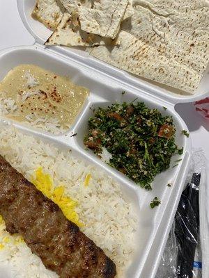 Beef Luleh Lunch Special with basmati rice and sides of hummus, tabbouleh, and pita.