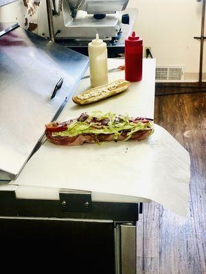 Assorted sub, capicola, salami, bologna, lettuce to manual onion oil mayonnaise toasted sub