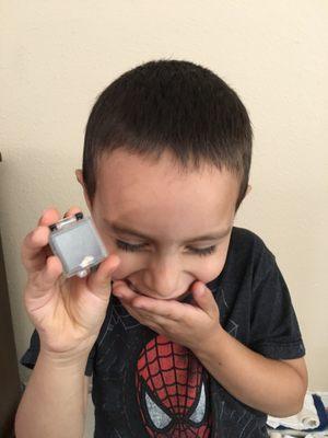 My 4 year old son holding his tooth.