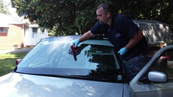 Setting the windshield in the vehicle must be done carefully and precisely to ensure the adhesive meets the glass in the corr...