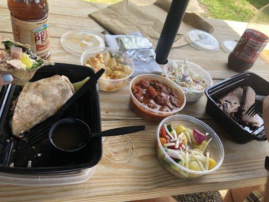 Smoked turkey bacon wrap with a side of Mac n cheese and a brisket platter with apple cole slaw and cucumber salad. Also pork and beans.