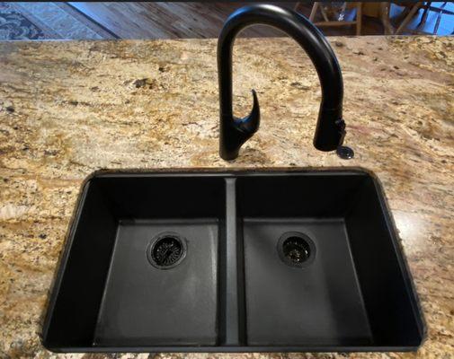 Composite granite sink installed under granite after removing original stainless steel sink.