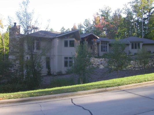 This house stands out even in a neighborhood of mansions; stucco, stone and sweeping roofs...