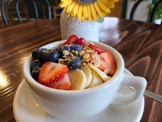 Fruit and yogurt parfait with granola and honey. Option to add protein powder