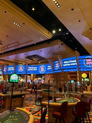 Table games and barstool banner next to cashier