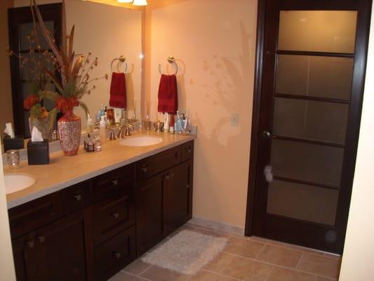 New bathroom with custom tile work and amish built cabinetry.