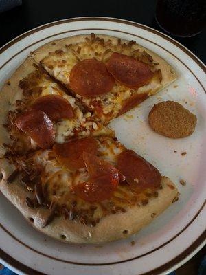 The frozen pizza topped with pepperonis and what tasted like microwaved, off-brand Tyson nuggets.