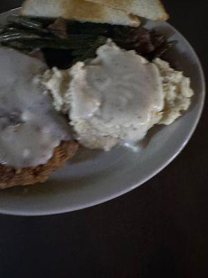 Chicken Fried steak with mashed potatoes and green beans.