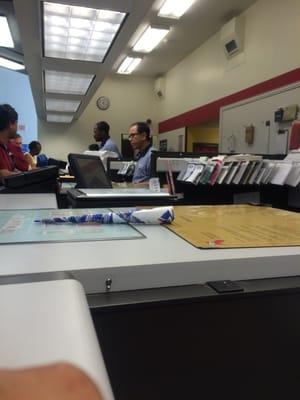 Post office employees waiting on customers