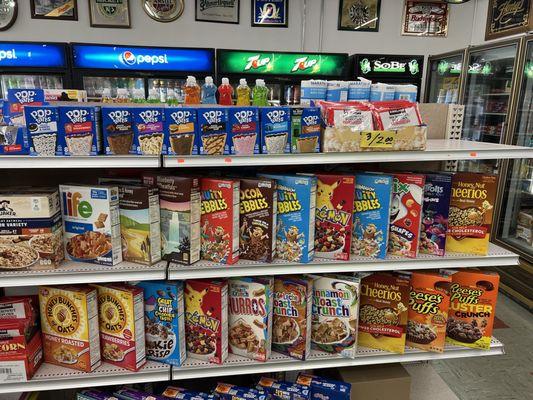 Well organized display of cereal boxes and pop tarts.