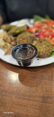 Build-your-own feats featuring falafel, salad, potato and pita chip.