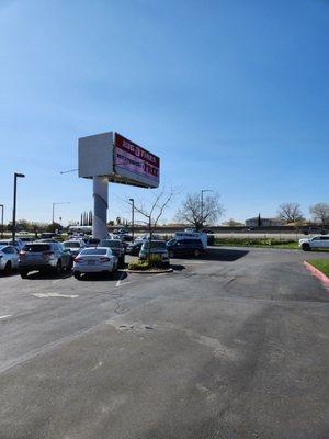 Paved lot. No trees. If hauling your equine, and it's over 85°, be kind and park under the digital billboard!