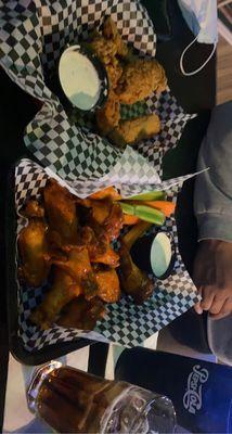 Hot wings & chicken tenders Drinks are Pepsi & the other is a Jack and Coke