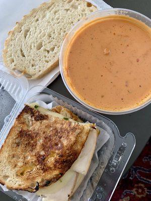 Panini-pressed in cafe Turkey, Provolone & Arugula Sandwich, Tomato Bisque Soup of the day with Sourdough slice