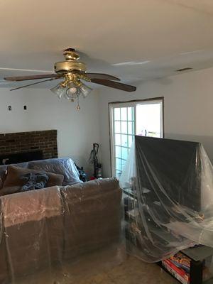 demo an entire living room, new drywall, base, and flooring.