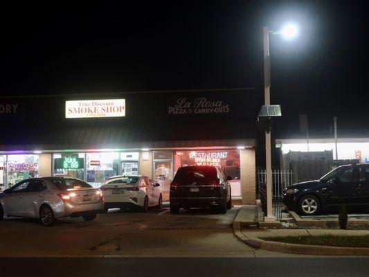 An evening view of their strip mall storefront.