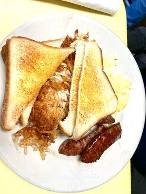 Eggs, hash browns smoke sausage and toast