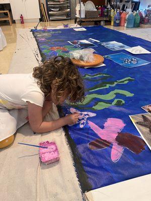 Painting sea creatures on a shared mural for our annual Family Festival