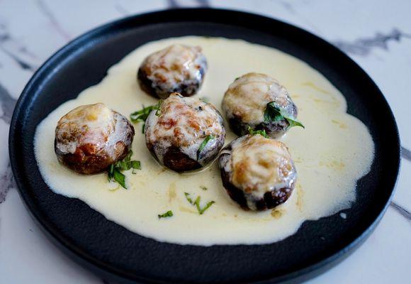 Papa's Mushrooms - 
Mushroom caps filled with veal, breadcrumbs, topped with Fontina cheese and finished with lemon-butter basil sauce