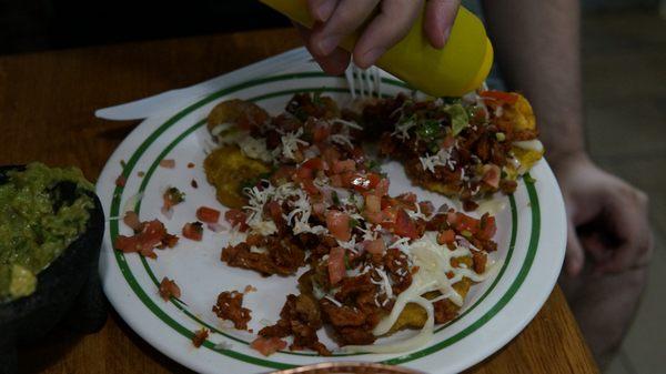 Tostones a la Mexicana. Think of it as Nachos made with Green Fried Plantains. Pick your meat and go. So good!