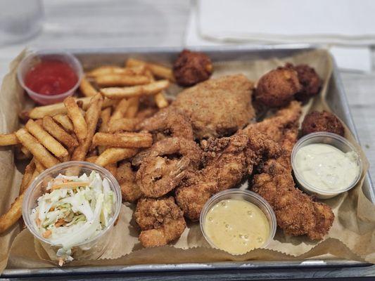 Pick three. Shrimp deviled crab chicken tenders. Fries coleslaw . The deviled crab was really good