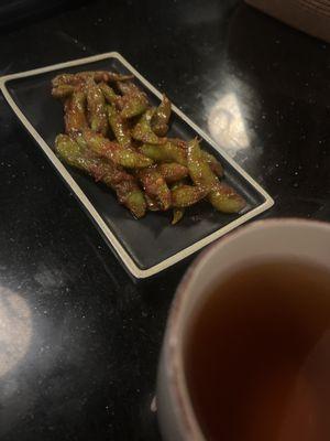 Hot tea and Edamame with spice.