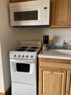 Kitchen area. I'm obsessed with the little oven/stove