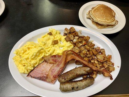 "The Roughneck" Three scrambled eggs, two bacon, two sausage, thick ham slab, country potatoes, three pancakes.