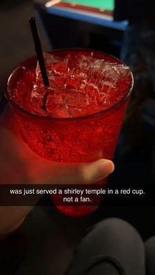 Shirley temple in a red cup with no maraschino cherries