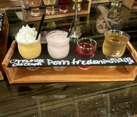 Build your own flight with orange cream ice cream wine slush, pomegranate slush, Fredonia wine, and mango cider!