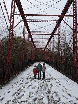 Red bridge over entrance road getting in to the park.