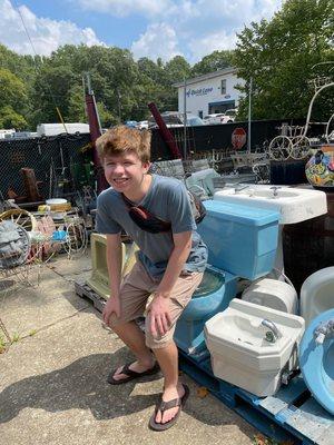 A family member using a blue toilet