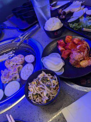 Bean sprouts, sliced radish, kimchi, fermented radish, chicken and veggies on the grill