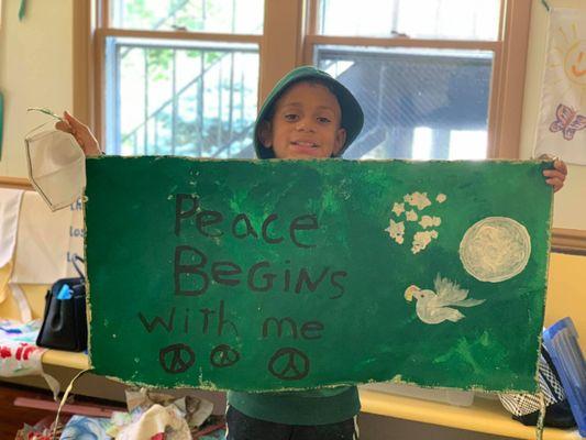 My son happily holds his peace banner. FMS is a huge promoter of peace.