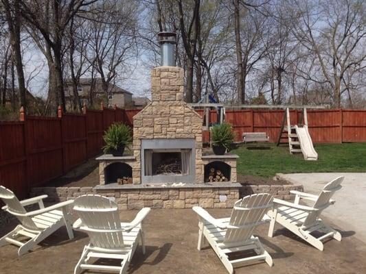 Custom fireplace and stamped concrete patio.