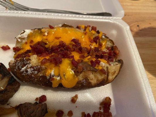 Baked potato with salt butter cheese and bacon