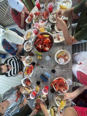 Lobster, steamers, potatoes, bread, sausage, salad, fixings