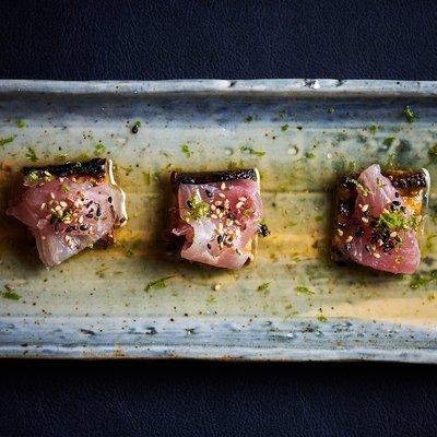 Montauk Sea Bream Sashimi on top of charred japanese eggplant, smoked olive oil, white soy dashi