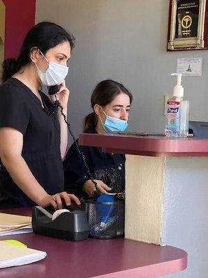 Mask worn below receptionists nose after I told her to cover her nose.