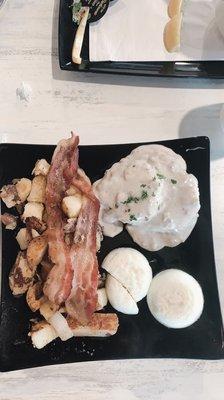 Biscuit and gravy special w 2 egg bacon and seasoned red potatoes