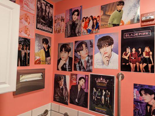 Lots of Kpop posters in the bathroom