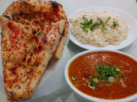 Garlic naan, Chicken Tikka Masala. Note the diced garlic is red in color. There are also herb toppings. Very good presentation.