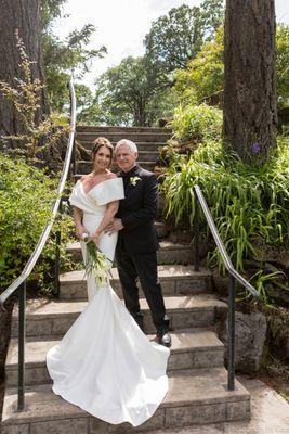 Bride and Groom standing on a staircase.