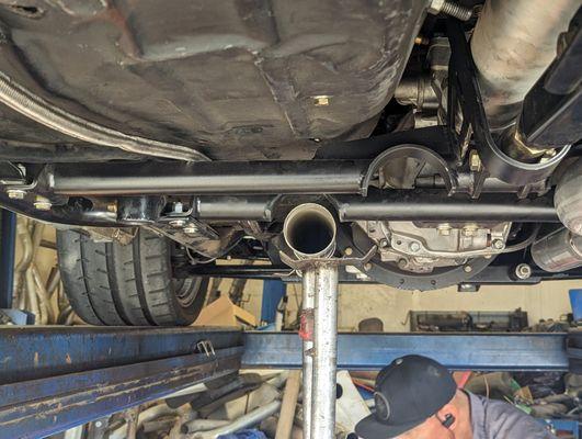 Got my new exhaust cleanly tucked up under the car and using the exhaust relieves in the cross member for a tight custom fit.