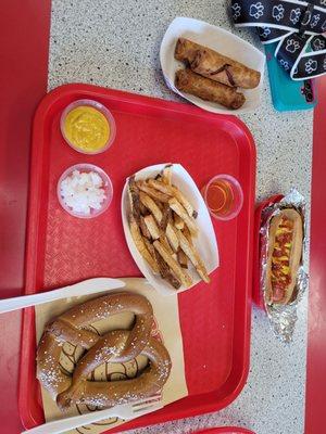 Soft pretzel, fries, dog, and pizza rolls