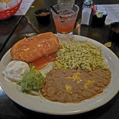 Shredded chicken chimichanga w/ ranchero sauce and poblano rice & refried beans