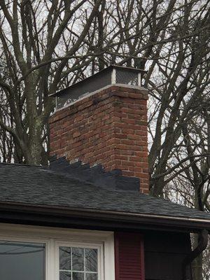 Repaired flashing and new chimney cap.